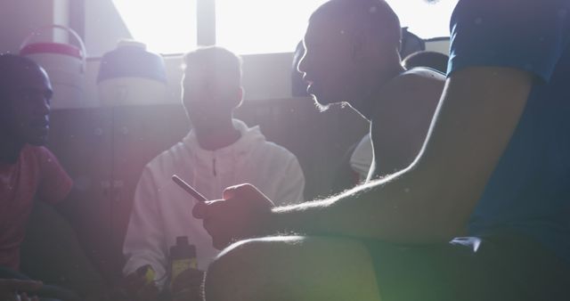 Group of Diverse Men Talking and Using Smartphone in Gym - Download Free Stock Images Pikwizard.com