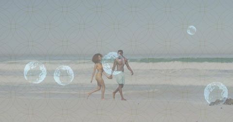 Romantic Young Couple Walking Along Peaceful Beach