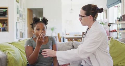 Young Girl with Inhaler Consulting Doctor at Home