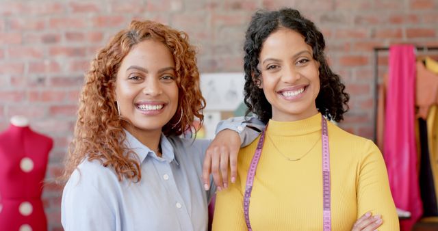 Two Confident Female Fashion Designers Smiling in Modern Studio - Download Free Stock Images Pikwizard.com