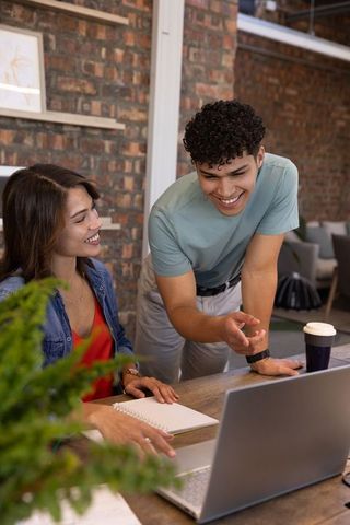 Team collaboration in modern workspace with coworkers engaging at desk