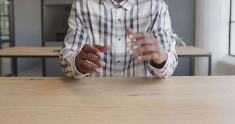 Business Professional Discussing Strategy With Hand Gestures at Office Desk
