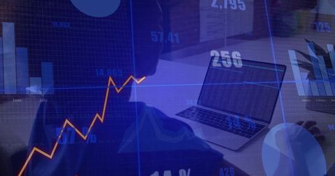Data analyst reviewing financial charts on laptop