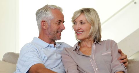 Happy Mature Couple Relaxing at Home on Couch