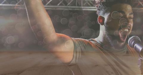 Energetic male vocalist performing on concert stage