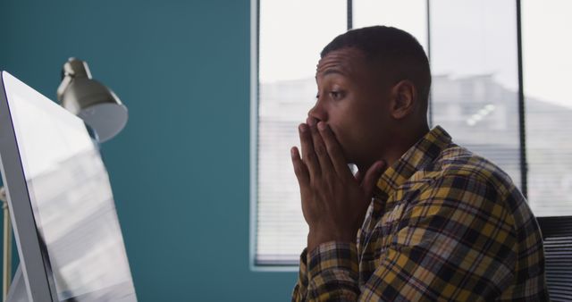 Surprised Young Man Looking at Computer Screen in Office - Download Free Stock Photos Pikwizard.com