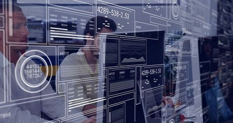 IT team analyzing real-time dashboards and code with transparent HUD overlays in office
