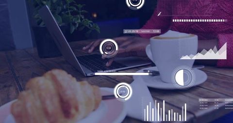 Typing and working remotely at cafe laptop coffee croissant showing digital HUD analytics