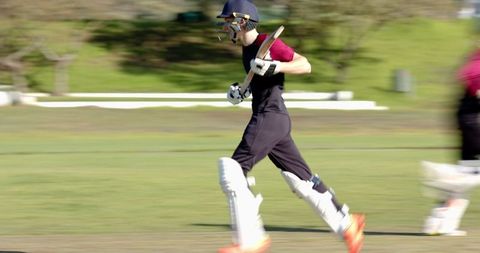 Dynamic Cricketers Running on Field in Exciting Match