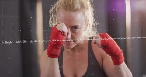 Fit Woman Boxing with Red Wraps and Waveform Overlay in Gym