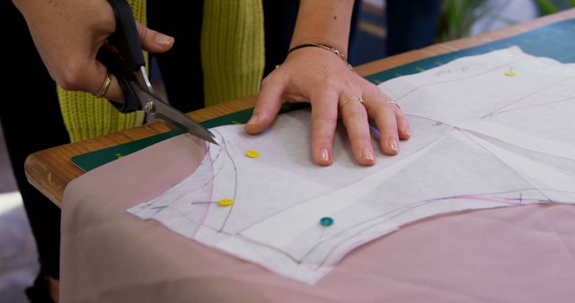 Person Cutting Fabric with Scissors in Workshop Setting - Download Free Stock Images Pikwizard.com