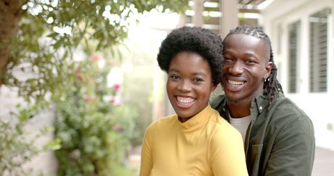 Joyful African American Couple Embracing Outdoors under Pergola