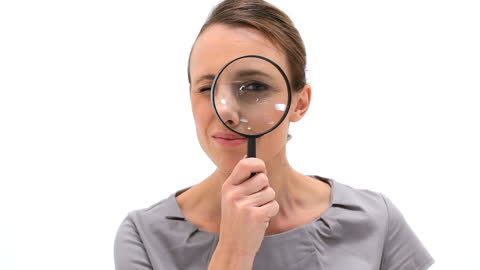 Smiling Woman Using Magnifying Glass for Close Examination