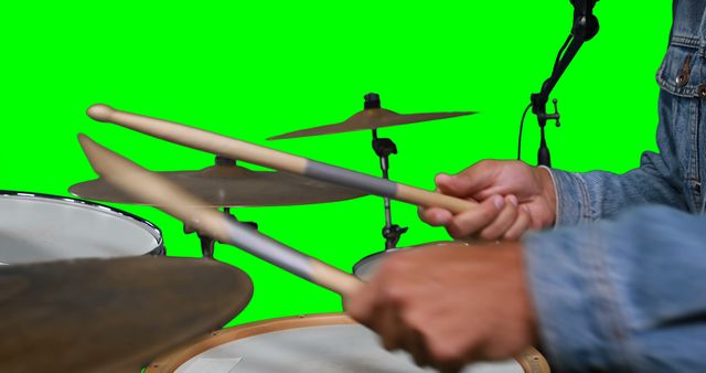 Mid section of drummer playing drum against green screen - Download Free Stock Photos Pikwizard.com