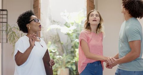 Young couple touring modern home with real estate agent