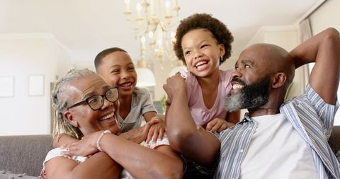 Joyful African American Family Sharing Happy Moments in Living Room