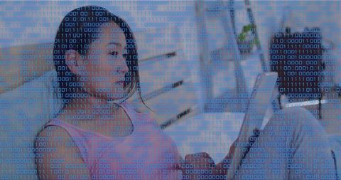 Mid-adult korean woman holding tablet with binary code overlay in modern living room scene