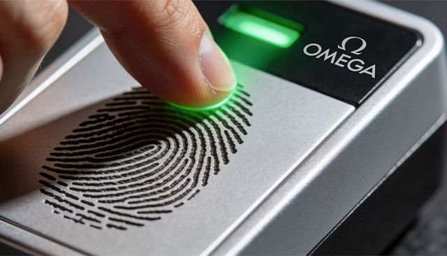 Pressing fingertip on biometric fingerprint scanner with green led for secure access