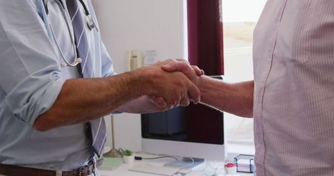 Doctor Supporting Elderly Patient with Handshake in Clinic - Download Free Stock Images Pikwizard.com