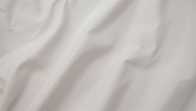 White fabric with soft folds and shadows highlighting texture