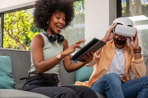 Diverse Friends Engaging with Virtual Reality Technology in Modern Living Room