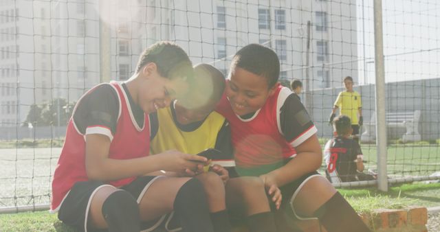 Young Soccer Players Enjoying Break with Smartphone - Download Free Stock Images Pikwizard.com