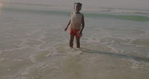 Young Girl Enjoying Ocean Waves on Breezy Beach Day