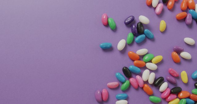 Overhead View of Multicoloured Sweets Falling on Purple Background - Download Free Stock Images Pikwizard.com