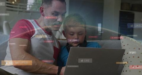 Father guiding son on laptop with social media overlays at home, learning and bonding