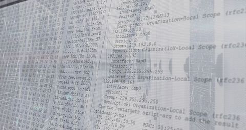 Translucent monitor displaying network logs with urban skyline reflection cybersecurity