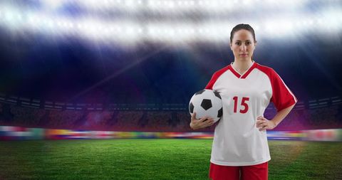 Confident Female Soccer Player Holding Ball in Stadium under Bright Lights - Download Free Stock Images Pikwizard.com
