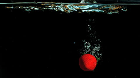 Strawberry Splash in Water Against Black Background