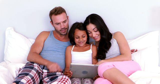 Happy Family Relaxing in Bed Using Tablet - Download Free Stock Images Pikwizard.com