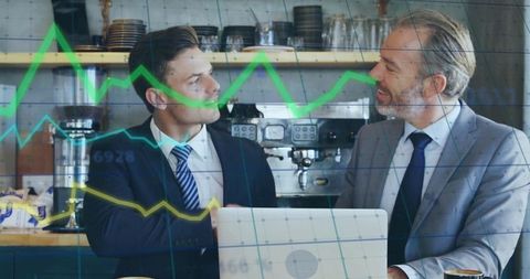 Two Businessmen Shaking Hands in Front of Financial Graph Overlay