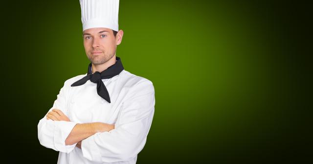 Portrait of confident chef standing with arms crossed against green background