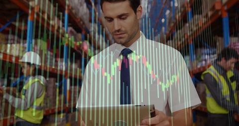 Supervisor Analyzing Data with Tablet in Modern Warehouse Environment