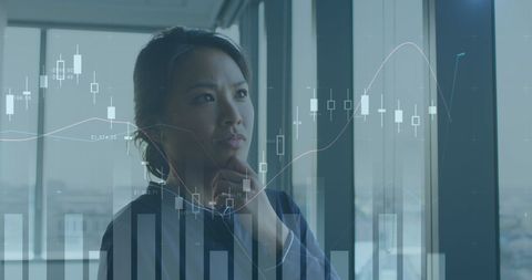 Thoughtful Woman Analyzing Financial Data in Modern Office