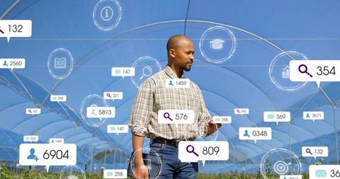Farm manager inspecting smart greenhouse crops with tablet and agritech analytics overlays