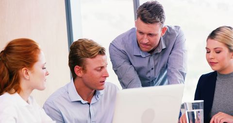Team Discussing Project Strategies Around Laptop in Office Meeting - Download Free Stock Images Pikwizard.com