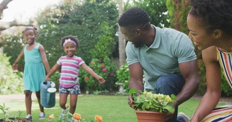 Happy Family Gardening Together in Backyard