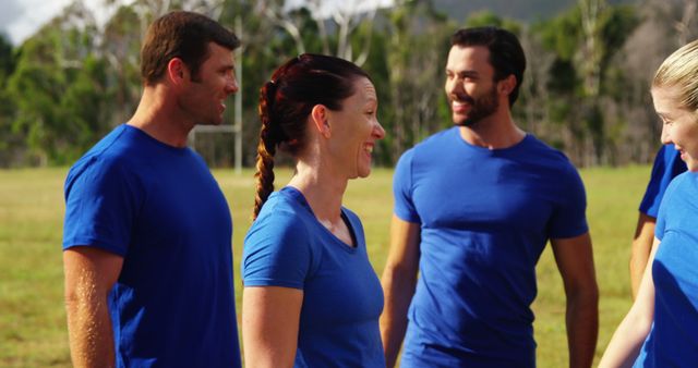 Group of Adults Engaging in Outdoor Team Activity in Blue Shirts - Download Free Stock Images Pikwizard.com