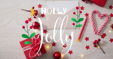 Holly jolly holiday flatlay featuring candy cane heart, gift, red ornaments and lights