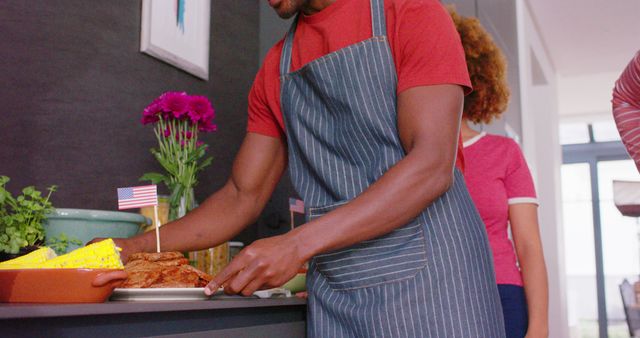 Man preparing food for American barbecue in kitchen - Download Free Stock Images Pikwizard.com