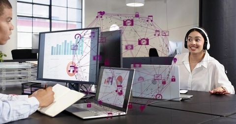 Collaborating on data analytics in modern office with headset and digital network overlay