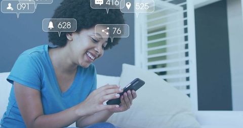 Smiling Woman Engaging with Social Media on Smartphone at Home