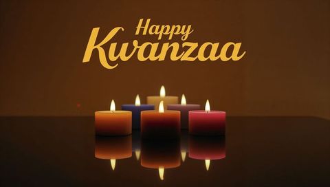 Happy Kwanzaa Candles Glowing and Reflecting on Glossy Tabletop with Warm Flames
