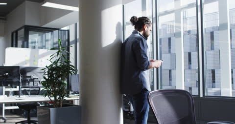 Professional Man Using Smartphone in Bright Modern Office