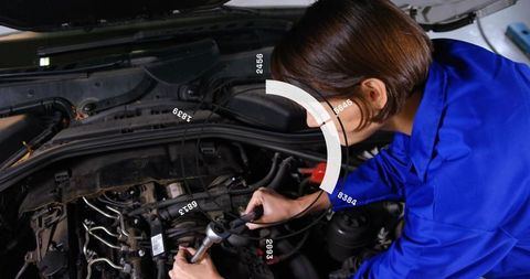 Mechanic Repairing Car Engine Using AR HUD Overlay While Tightening Intake Manifold