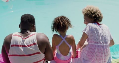Loving Family at Poolside Enjoying Sunny Day Outdoors