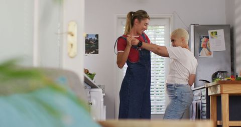 Joyful Female Couple Enjoying Cooking Dance